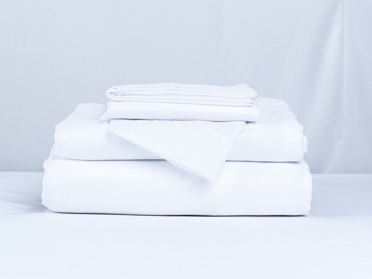 A neatly folded stack of crisp white linen