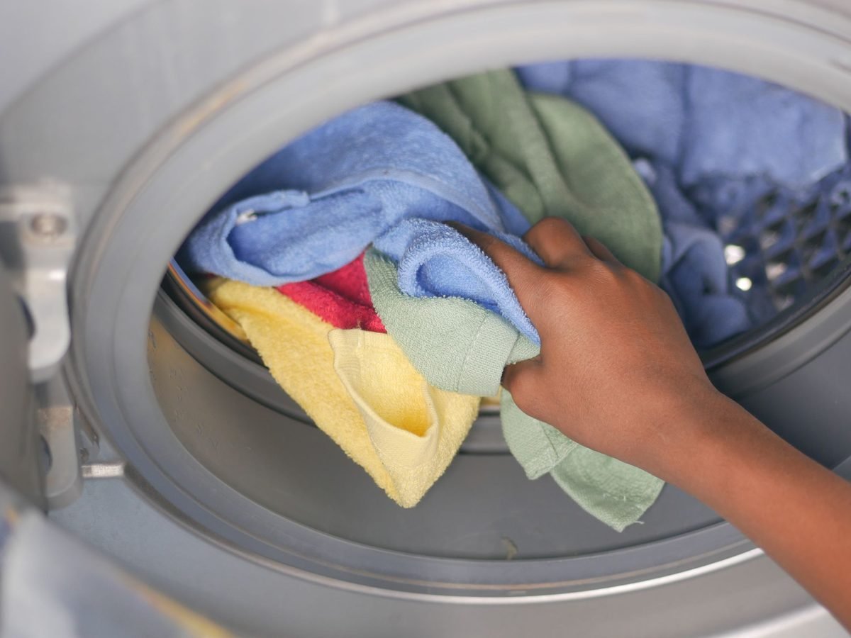 Towels going into a front-loading washing machine